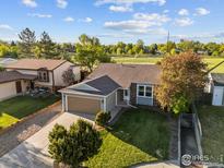 Charming single-Gathering home with lush landscaping and mature trees, situated on a well-manicured lot at 1512 Calkins Ave, Longmont, CO 80501