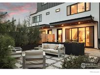 Charming outdoor patio with modern furniture, lush greenery, and ambient lighting perfect for relaxing or entertaining at 2248 S Lincoln St, Denver, CO 80210