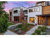 Modern townhome showcasing a landscaped front yard with a mix of greenery and colorful blooms, plus rooftop patios at 2248 S Lincoln St, Denver, CO 80210