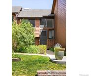 Charming townhouse featuring a cozy front yard with lush landscaping and a wooden exterior at 2725 Juniper Ave # 78, Boulder, CO 80304