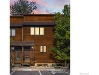 Charming townhouse featuring a wood exterior, inviting entrance, and professionally maintained landscaping at 3345 Hickok Pl, Boulder, CO 80301