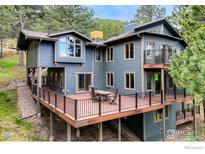 Stunning multi-level back deck perfect for entertaining with outdoor furniture at 335 Pine Tree Ln, Boulder, CO 80304