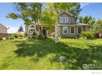 Charming two-story home featuring a well-maintained lawn and mature trees, providing shade and curb appeal at 531 S 9Th St, Berthoud, CO 80513