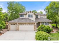Charming two-story home features a three-car garage, well-maintained lawn, and beautifully landscaped yard at 5348 Wild Dunes Ct, Boulder, CO 80301
