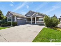 Charming home with a well-manicured lawn, complemented by a two-car garage and inviting front porch at 8852 E 152Nd Ct, Thornton, CO 80602