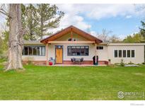Charming home with inviting front porch, perfect for enjoying the outdoors and relaxing afternoons at 9445 Lykins Pl, Boulder, CO 80301