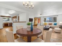 Eat-in kitchen and dining area with elegant dining table and comfortable seating arrangement at 1229 Juniper St, Longmont, CO 80501
