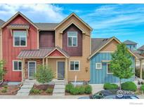 Charming multi-tone townhouse with welcoming entrance and neatly landscaped front yard at 1240 Wren Ct # B, Longmont, CO 80501