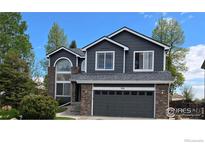Charming two-story home featuring a well-manicured lawn and a classic brick and siding exterior at 12742 Clermont St, Thornton, CO 80241