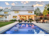 Stunning backyard with pool, firepit, and comfortable seating area, perfect for outdoor entertaining under string lights at 1505 Oak Ave, Boulder, CO 80304