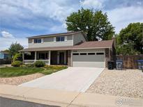 Charming two-story home with a well-manicured lawn and a two-car garage at 1545 S Vivian St, Longmont, CO 80501