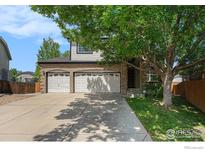 Charming two-story home with a brick facade, three-car garage, and a well-maintained lawn and landscaping at 1638 E 131St Cir, Thornton, CO 80241