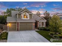 Charming two-story home featuring a two-car garage, brick accents and manicured lawn at 2841 Silver Pl, Superior, CO 80027