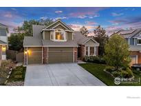 Charming two-story home featuring a three-car garage, brick accents, and a well-manicured lawn at 2841 Silver Pl, Superior, CO 80027