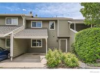 Inviting two-story townhouse featuring a carport and charming curb appeal with mature landscaping at 2977 Eagle Way, Boulder, CO 80301