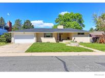 Charming one-story home with a well-manicured lawn, attached garage, and beautiful landscaping at 3375 Zephyr Ct, Wheat Ridge, CO 80033