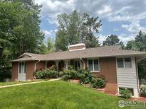 Charming single story brick home with mature landscaping and a well manicured lawn, providing great curb appeal at 1035 Rosehill Dr, Boulder, CO 80302