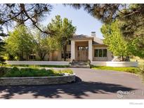 Beautiful home exterior featuring manicured landscaping, elegant entryway, and circular driveway at 160 Ponderosa Dr, Boulder, CO 80303