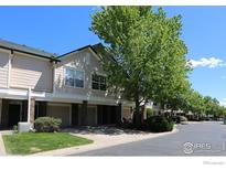 Well-maintained townhome exterior featuring a covered parking spot and beautiful landscaping at 1652 Egret Way, Superior, CO 80027