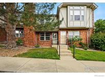 Charming red brick townhome exterior with a well-manicured lawn and inviting entrance at 3022 W 107Th Pl # D, Westminster, CO 80031