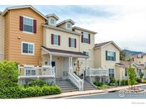 Inviting townhome features a charming porch and well-maintained landscaping, creating a welcoming curb appeal at 3860 Colorado Ave # C, Boulder, CO 80303