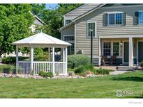 Inviting front exterior of home with a quaint gazebo and well-maintained lawn at 930 Button Rock Dr # 28, Longmont, CO 80504