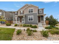 Charming two-story townhome with inviting curb appeal and neutral-tone exterior at 17616 Bluetrail Ave, Parker, CO 80134