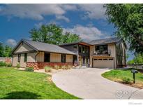 Charming two-story home features a modern design and well-manicured front yard and large driveway at 2575 Briarwood Dr, Boulder, CO 80305