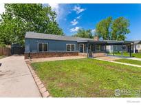 Charming single-story home featuring a covered porch, carport, and well-maintained lawn at 2749 S Glencoe St, Denver, CO 80222