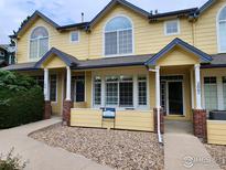 Charming townhome with covered porch, well-maintained landscaping, and inviting curb appeal at 2855 Rock Creek Cir # 200, Superior, CO 80027