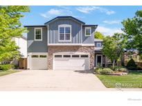 Charming two-story home featuring stone accents, a three-car garage, and professionally landscaped yard at 2933 Hunt Ct, Erie, CO 80516