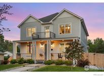 Charming two-story home featuring a welcoming front porch and balcony, perfect for enjoying the outdoors at 3256 S Corona St, Englewood, CO 80113