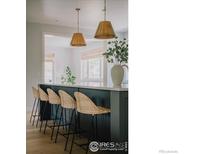 Stylish kitchen island with seating and modern pendant lighting at 3256 S Corona St, Englewood, CO 80113