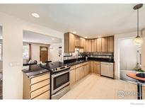 Well-lit kitchen features wooden cabinets, black countertops, and stainless steel appliances at 630 S 45Th St, Boulder, CO 80305