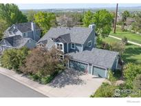 Charming two-story home with a three-car garage, beautiful landscaping, and mountain views at 902 Grove Dr, Louisville, CO 80027