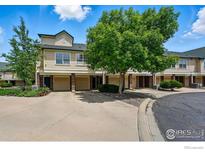 Charming townhome exterior with garages, brick accents, and mature trees in a well-maintained community at 1837 Spaulding Cir, Superior, CO 80027