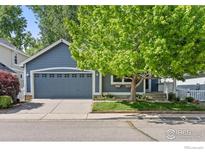 Charming single-Gathering home features a well-manicured lawn and attached two-car garage at 2106 River Walk Ln, Longmont, CO 80504