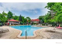 Community pool area with mature trees, lounge chairs, and well-maintained pool at 3250 Oneal Cir # 14, Boulder, CO 80301