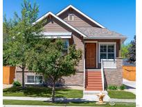 Charming brown two-story home with well-maintained lawn and inviting front porch at 3341 Yukon Ct, Wheat Ridge, CO 80033