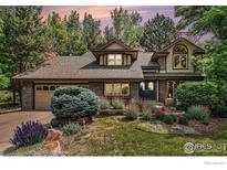 Charming home featuring brick accents, a well-manicured lawn, and mature trees, creating a picturesque curb appeal at 3441 W Dartmouth Ave, Denver, CO 80236