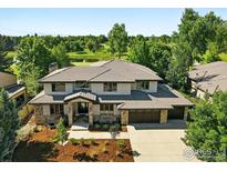 Stunning two-story home boasts stone accents, meticulous landscaping, and golf course views at 7205 Rustic Trl, Boulder, CO 80301