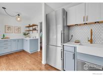 Charming kitchen featuring two-tone cabinets, stainless steel appliances, and a farmhouse sink at 790 W Moorhead Cir # A, Boulder, CO 80305