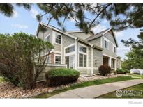 Inviting townhome featuring a two-story facade with lots of natural light and rock landscaping at 805 Summer Hawk Dr # 100, Longmont, CO 80504