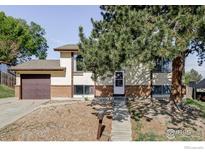 Charming two-story home with a well-manicured front yard and a classic brick and siding exterior at 8125 Downing St, Denver, CO 80229