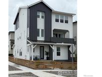 Charming two-story home with a modern design, featuring a cozy front porch and contrasting siding accents at 926 Hearteye Trl, Lafayette, CO 80026