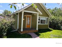 Charming home featuring an inviting front porch, well-maintained lawn, and attractive landscaping at 936 Parkview St, Louisville, CO 80027