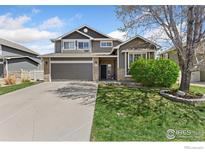Charming two-story home with a well-manicured lawn and attached two-car garage at 9930 Cascade St, Firestone, CO 80504