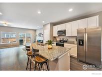 Modern kitchen with stainless steel appliances, granite countertops, and an open layout at 14700 E 104Th Ave, Commerce City, CO 80022