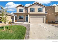 Charming two-story home with landscaped yard, covered porch and a two car garage at 18813 E 99Th Ave, Commerce City, CO 80022