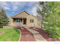 Charming home featuring stone accents, a cozy front porch, and a well-manicured lawn at 3008 Mountain Sky Dr, Castle Rock, CO 80104